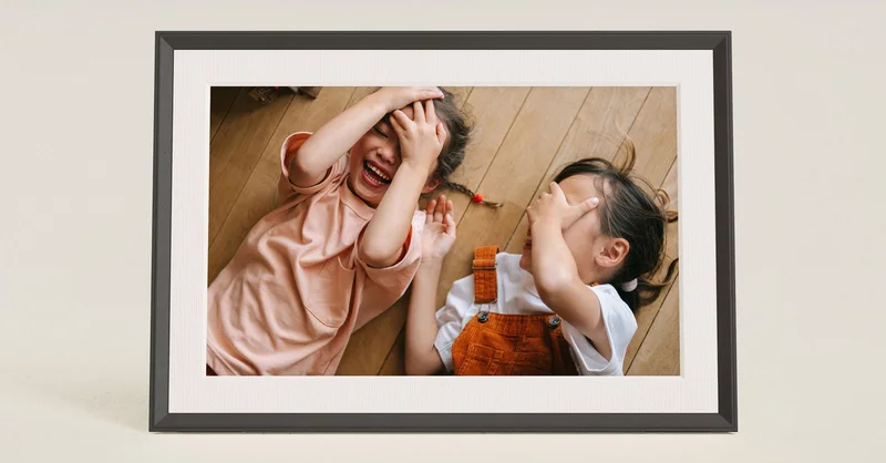 Aura Carver Mat digital photo frame showing a landscape image with a textured matted border