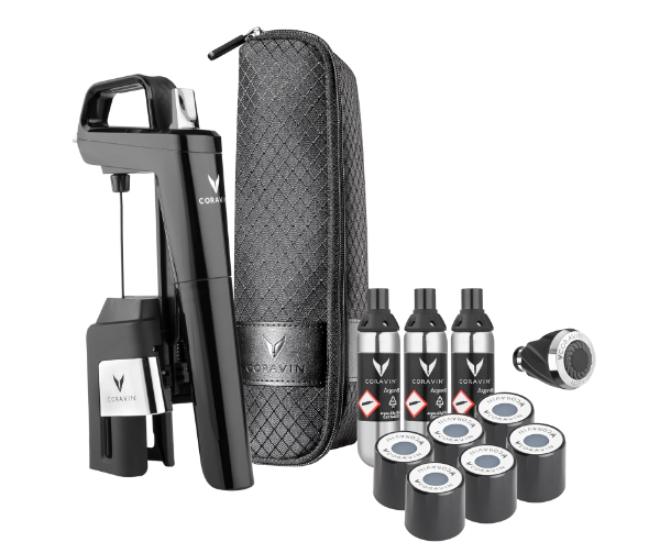 Coravin Timeless Six Plus wine preservation system on a table with wine glasses