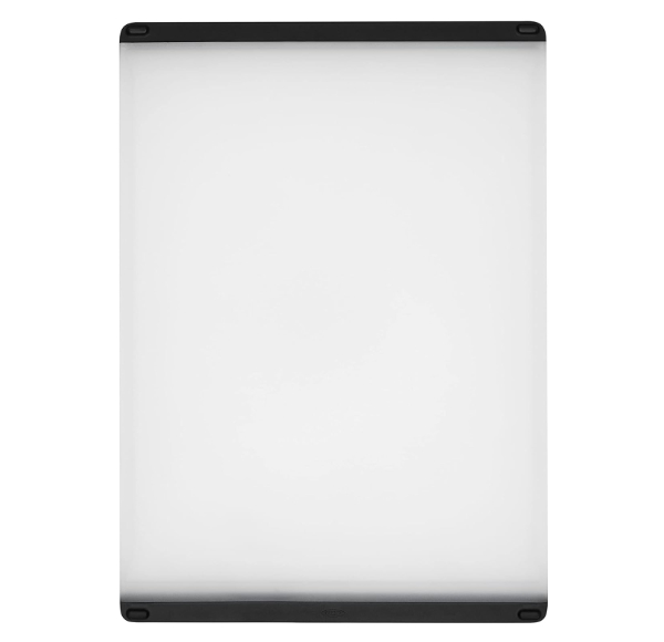 OXO Good Grips Utility Cutting Board with black non-slip edges and white plastic surface